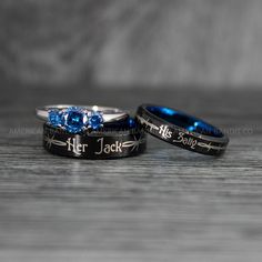 two wedding rings with blue sapphire stones on them, one for her and the other for him