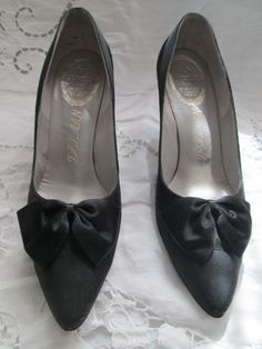 "Cute black 3\" heel pumps, in a sateen-like fabric with a large satin bow on front of shoe. Shoes are in a size 8 1/2 AA, in great condition. They also have a satin trim around top of shoe back/sides. PRICE IS $79.00SALE FINAL/AS IS/NO RETURNS." Round Toe Heels With Satin Bow For Evening, Evening Heels With Satin Bow And Round Toe, Classic Evening Heels With Bow, Formal Closed Toe Heels With Satin Bow, Formal High Heel Heels With Satin Lining, Formal High Heels With Satin Lining, High Heel Court Shoes With Bow For Evening, Formal Closed Toe Court Shoes With Bow, Vintage High Heel Court Shoes For Party