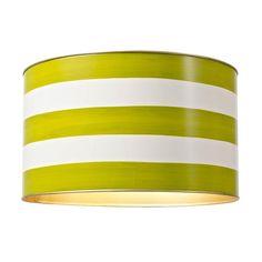 a green and white lamp shade hanging from a ceiling fixture with stripes on the fabric