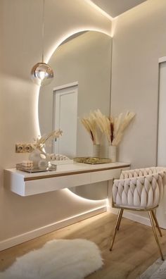 a white chair sitting in front of a mirror on top of a counter next to a table