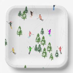 a white tray with skiers and trees on it