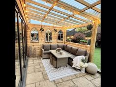 an outdoor living area with patio furniture and string lights