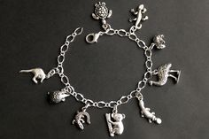 A collection of silver plated Australian wildlife themed charms have been dispersed around a shimmering silver plated bracelet chain in this handmade charm bracelet. This Australian wildlife charm bracelet is then completed with a lobster clasp and a 1/2 inch of chain at the end for adjustable sizing. Charms in this bracelet include a kangaroo charm, echidna charm, crocodile charm, koala charm, platypus charm, emu charm, wombat charm, gecko charm, and a sea turtle charm. ● Sizing ● To determine Handmade Charm Bracelets, Australian Wildlife, Turtle Charm, Silver Plated Bracelet, Platypus, Bracelet Chain, Silver Charm Bracelet, Emu, Bracelet Handmade