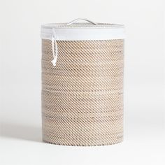 a large woven basket with white handles on a white background, the lid is open