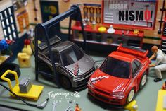 toy cars are displayed on a table with other toys