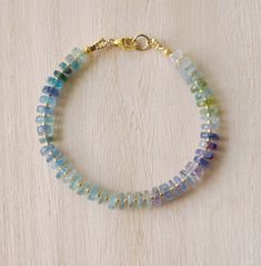 Fluorite is said to absorb and neutralize negative energy & stress. It is also believed to increase concentration, self-confidence, and help in decision-making. This bracelet is handcrafted with genuine Fluorite ranging blues, greens, and purples. Each stone is slightly different in width and has a tiny gold or silver bead between. STONE SIZE: 6mm SIZING: Please measure your wrist to find your size before purchasing. If purchasing as a gift the adjustable size of 6.5 to 7.5" fits most average wo Fluorite Gemstone Bracelets With Round Beads, Healing Gemstone Gold Bracelets, Gold Gemstone Bracelets For Healing, Gold Gemstone Bracelet For Healing, Fluorite Natural Stone Beaded Bracelets As Gift, Fluorite Gemstone Beads Bracelets For Healing, Handmade Fluorite Beaded Bracelets As Gift, Spiritual Fluorite Bracelets With Gemstone Beads, Fluorite Gemstone Beads Bracelet For Healing