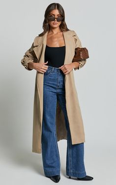 Elevate your outerwear game with the Mella Coat in Camel! This belted longline coat is perfect for adding a touch of sophistication to any outfit. Made from a cozy twill polyester blend, this coat is not only stylish but also practical for those colder days. With its brown hue and classic silhouette, it's the ultimate staple piece for your winter wardrobe. Whether you're heading out for a casual day or dressing up for a night out, this long sleeve coat will keep you looking effortlessly chic and Long Coat And Jeans Outfit, Outfit With Coat Winter, Winter Outfits 30 Year Old Woman, 15 Degrees Outfit, Jeans And Coat Outfit, City Girl Winter Outfit, Brown Wool Coat Outfit, Winter Fashion Jeans, Long Trench Coat Outfit