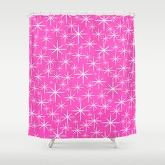 a pink shower curtain with white stars on it