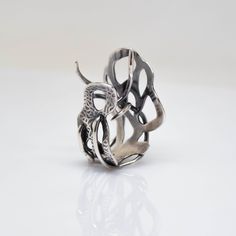 A sculptural piece inspired by microscopic forms, the Myth Ring explores the beauty and mystery of life. An edgy statement ring that is playful, flirtatious, and moody. The ring's open design can accommodate sizes 7 to 8.5. One-of-a-Kind Size 7. Adjustable up to size 8.5 Sterling Silver To get your ring size, click here for our Ring Sizing Form. Learn about the energetic properties of the metals or gemstones in this design here In-stock and Ready-to-Ship items ship within a 2-3 day process. Modern Twist Jewelry With Unique Open Ring Design, Modern Twist Jewelry Ring With Unique Design, Unique Sterling Silver Open Snake Ring, Artistic Metal Rings With Unique Design, Artistic Open Ring With Unique Design, Unique Handmade Freeform Ring, Unique Metal Snake Ring With Open Design, Unique Metal Open Snake Ring, Fusion Style Open Ring With Unique Design