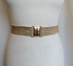 Silver or Gold Waist cincher Elastic Stretch belt Statement accessory Light silver elastic belt.  Wide 1- 1/2"or 4cm. Powerful and fantastic! WHEN ORDERING: Extra small (0-2) Fits waists 23" - 25" Measures 21.5" end to end including clasp Small (4-6) Fits waists 26" - 27" Measures 24 1/2" end to end Medium (8-10) Fits waists 28" - 29" Measures 26" end to end Large (12-14) Fits waists 30" - 33" Measures 28" end to end Extra large (16-18) Fits waists 34" - 37" Measures 32" end to end 2X Extra larg Elegant Formal Belt With Gold-tone Hardware, Luxury Gold-tone Elegant Chain Belt, Leather Belt With Gold-tone Hardware For Evening, Luxury Evening Belts With Gold-tone Hardware, Luxury Belts With Gold-tone Hardware, Gold Belt, Gold Belts, Stretch Belt, Waist Cincher