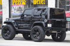 a black jeep parked in front of a store