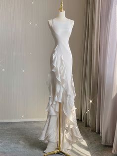 a dress on a mannequin in front of curtains