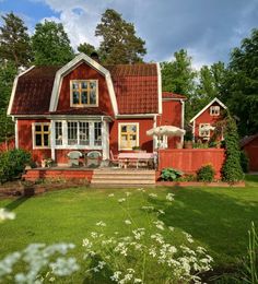 a red house with white trim and windows