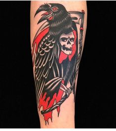 a person with a tattoo on their arm that has a crow and skull on it