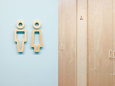 two wooden objects are on the wall next to a blue room with wood doors and drawers