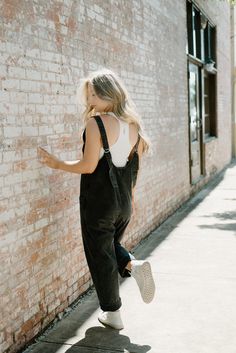 Elevate your street style with our Black Denim Overall Jumpsuit! Featuring a scoop neck, scoop back, and adjustable straps for a comfortable fit, this jumpsuit also includes convenient pockets on both sides. Embrace the versatility and edginess of this black wash denim piece. 100% cotton little stretch with loose fit model, Emi is 5'6" and wearing a size small Overall Jumpsuit, Boutique Trends, Free People Style, Sporty Girls, Black Jumpsuit, Long Sweaters, Street Style Women, Denim Wash, Spring Outfit