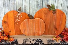 two wooden pumpkins sitting on top of a table