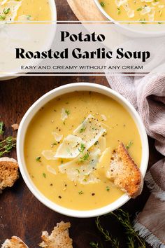 two bowls of potato roasted garlic soup on a wooden table with toasted bread and parsley