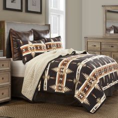 a bed in a bedroom with brown and white comforter