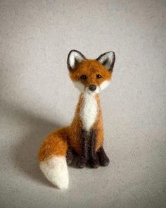 a needled fox sitting on the ground