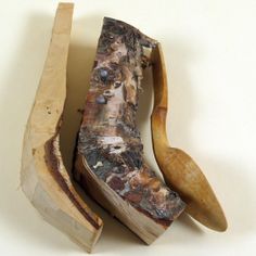 a piece of wood that has been cut in half with a wooden spoon next to it