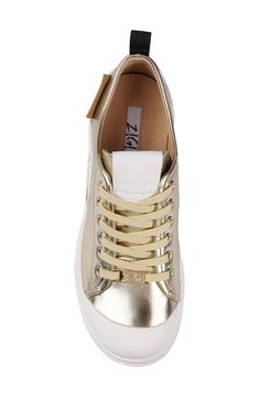 A ridged platform and extended toe cap add modern charm to this canvas lace-up sneaker finished with gleaming eyelets and a signature patch. 2" heel; 1" platform Textile upper/leather lining/synthetic sole Imported Gold Lace-up Sneakers With Metallic Logo, Low-top Leather Platform Sneakers With Metallic Logo, Gold Low-top Platform Sneakers, Gold High-top Sneakers With Round Toe, Low-top Platform Sneakers With Metallic Logo, Trendy Canvas Platform Sneakers With Laces, Trendy Gold Sneakers With Laces, Low-top Platform Sneakers With Lug Sole In Canvas, Low-top Canvas Shoes With Lug Sole