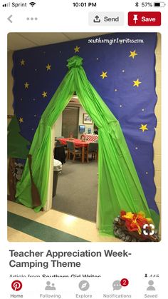 a room decorated in green and blue with stars on the ceiling, as well as a tent