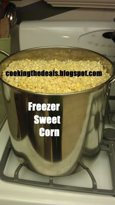 a pot filled with corn sitting on top of a stove