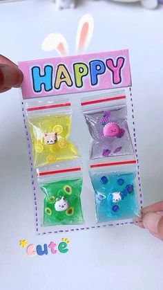 a person holding up a small package with different candies in it