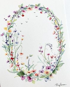 a watercolor painting of flowers in a circle