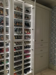 the closet is filled with many pairs of shoes