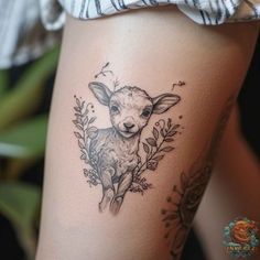 a tattoo on the thigh of a woman's leg with a deer and flowers