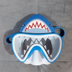 a blue and white mask with a shark's mouth on the top of it