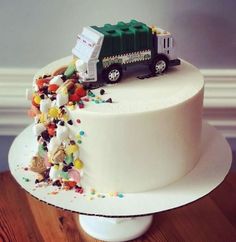 a white cake with a green truck on top