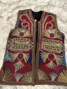 Stepping back in time with this vintage unisex Afghan/uzbek waistcoat. Every stitch tells a story, every pattern a piece of history. Handmade. Vintage. - Sizes available: S,M,L Bohemian Patchwork Vest For Festivals, Bohemian Sleeveless Embroidered Outerwear, Festive Bohemian Vest, Bohemian Multicolor Festive Vest, Multicolor Bohemian Vest For Festive Occasions, Traditional Embroidered Sleeveless Outerwear, Multicolor Bohemian Festive Vest, Vintage Handmade Festival Outerwear, Bohemian Sleeveless Vest For Festivals