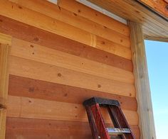 a ladder leaning against the side of a wooden building