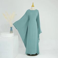 An elegant understatement of a dress- made of high quality crepe jazz fabric with beautiful batwing sleeves and a complimentary waist, the Bella Batwing Sleeve Abaya Maxi Dress can compliment any figure. Available in 8 stunning colors Batwing Maxi Dress, Cotton Abaya, Burqa Designs, Dress Soiree, Abaya Pattern, Batwing Dress, Kaftan Abaya, Muslim Women Fashion, Scarf Women Fashion