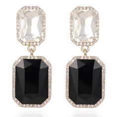 pair of black and white stone earrings with crystal stones in the center, on a white background