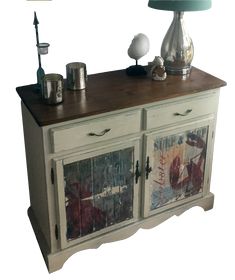 a white cabinet with two drawers and a lamp on top