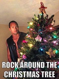 a man standing in front of a christmas tree with the caption rock around the christmas tree