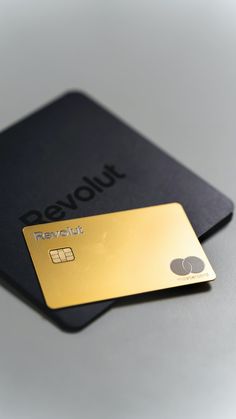 two credit cards sitting next to each other on top of a white table with the word payout printed on it