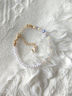 FOR OTHER DAINTY BEADED BRACELETS: https://www.etsy.com/ca/shop/ArtiChouXCanada?ref=seller-platform-mcnav%C2%A7ion_id&section_id=46088511 Bracelet Length: 13-19cm (5.1-7.4 inches) with a 14k gold filled extender.  This bracelet features an assortment of crystals and faux pearls.  Thread may be visible since it is a handmade product   SIZING  Wrap a soft measuring tape snugly around the widest part of your wrist. Add 1.27cm (0.5in) to that measurement to determine the right bracelet size.  MATERI White Minimalist Charm Bracelet, Dainty White Charm Bracelet For Everyday, Delicate White Adjustable Crystal Bracelet, Minimalist White Beaded Crystal Bracelet, Handmade Minimalist Crystal Bracelet With Round Beads, White Dainty Chain Bracelet With Round Beads, Dainty White Chain Bracelet With Round Beads, Handmade Minimalist Crystal Bracelet, Dainty White Round Beads Chain Bracelet