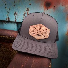 This customized hat is great for every Lineman who works hard to keep our power on. The leather patch in front will come with your Initials on either side of the cross arrows and your state on the bottom. The Lineman will sit on top. If you are looking for a different emblem please let us know and we will see if we can find it. This is a one size fits most, adjustable snap back Richardson original 112 trucker hat in gray and black. We can use any country/state on these hats. If you need one not Custom Outdoor Hat With Flat Bill, Custom Flat Bill Hat For Outdoor, Custom Outdoor Snapback Hat, Custom Outdoor Baseball Cap With Flat Bill, Custom Flat Brim Snapback Hat For Outdoor, Trucker Hat With Leather Patch, Six-panel, Custom Flat Brim Trucker Hat For Outdoor, Custom Adjustable 5-panel Hat, Custom Trucker Hat With Curved Brim For Outdoor