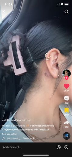 a woman with ear piercings in the back seat of a car