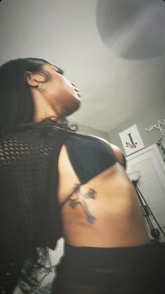 a woman with a cross tattoo on her back