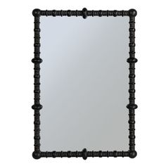 a black framed mirror with beading around the edges and an ornate design on the frame