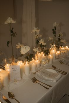 the table is set with candles and place settings