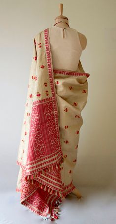 "This is hundred percent authentic Muga Silk Saree . It has Muga silk in the warp and weft . The interwoven motif yarns are in Guna ( golden zari ) and Acrylic. The design is traditional and known as Gamkharu and one of the most iconic designs of the region. The red and Muga combination is the classic combination that was always part of the bridal trousseau. Muga Silk - The most valued silk from India. Almost exclusively reared and produced in Assam, India. It is indigenous to the Brahmaputra Va Assamese Motifs, Muga Silk Saree, Mekhela Sador, Assam Silk Saree, Muga Silk, Bridal Trousseau, Formal Saree, Western Outfits Women, Work Sarees