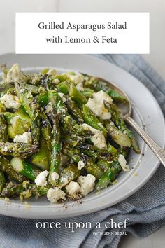 grilled asparagus salad with lemon & feta on a white platter