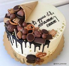 a decorated cake with chocolate and pretzels on top